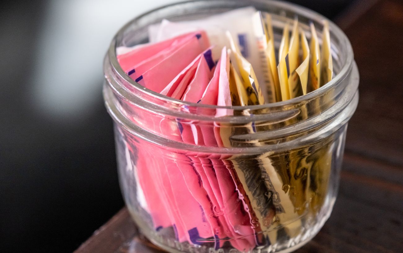 A glass container of artificial sweeteners.