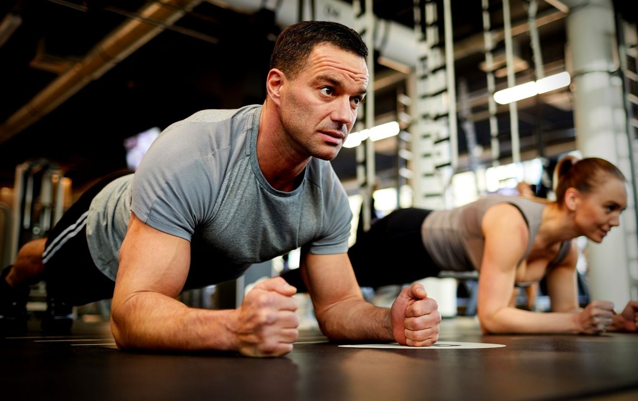 Two people doing forearm planks.