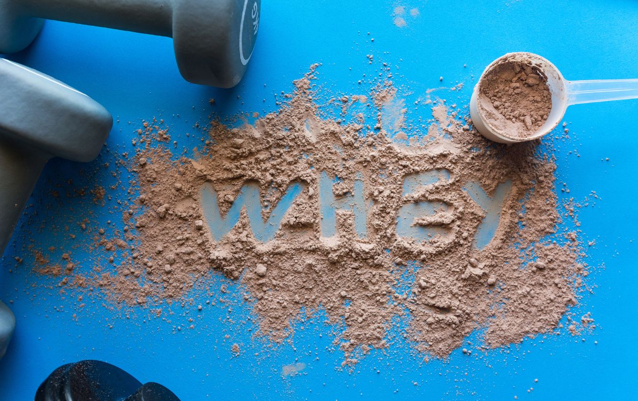 the word "whey" written in chocolate protein powder.